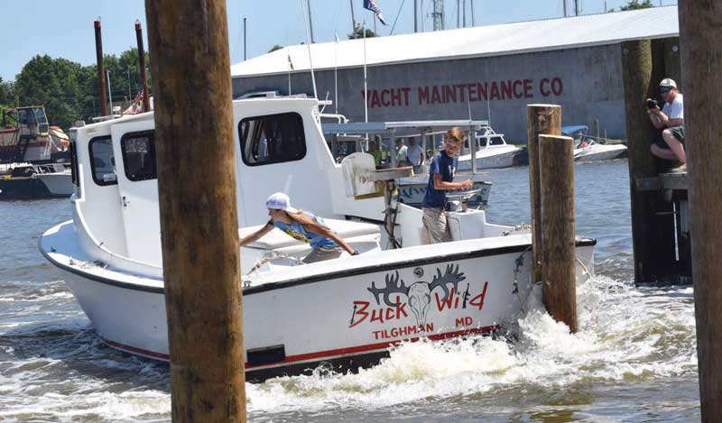 Hayden Wilson steers and Sidney Hughes throws the lines during the Dorchester County Chamber of Commerce Boat Docking contest. Photo by Dave Ryan/Dorchester Banner for the Chesapeake Cowboys