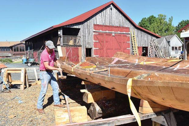 Boatyard manager Michael Gorman driving in the last iron pins, called drifts, to hold the bottom logs of the Edna E. Lockwood together in the yard at Chesapeake Bay Maritime Museum in St. Michaels, MD.