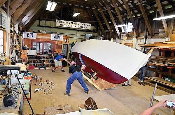 Turning the completed hull of Miss Polly in the Ruark Boatworks shop at Richardson Maritime Museum in Cambridge, MD.