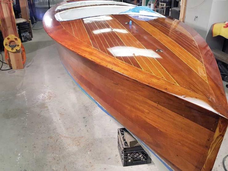 Gin Mill, a 22 foot Hacker Craft, sports newly varnished topsides and deck at Classic Water Craft Restoration in Annapolis, MD.