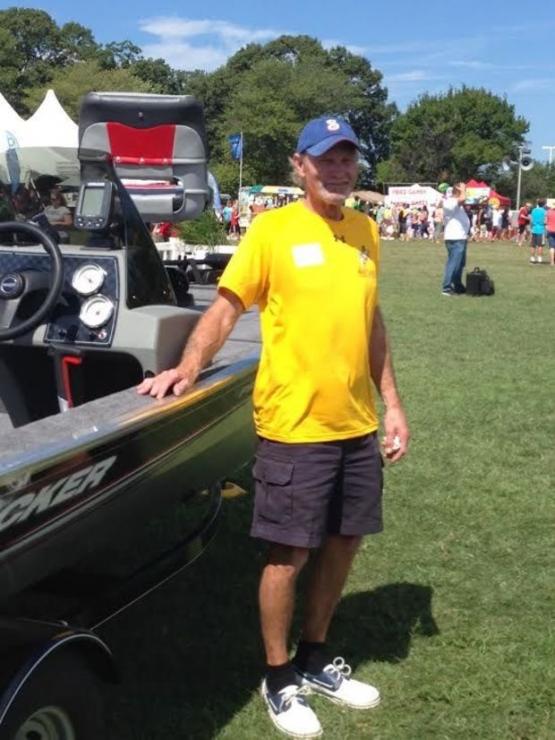 Rick Snider standing proudly with his new fishing boat courtesy of Tracker Boats and Bass Pro Shops