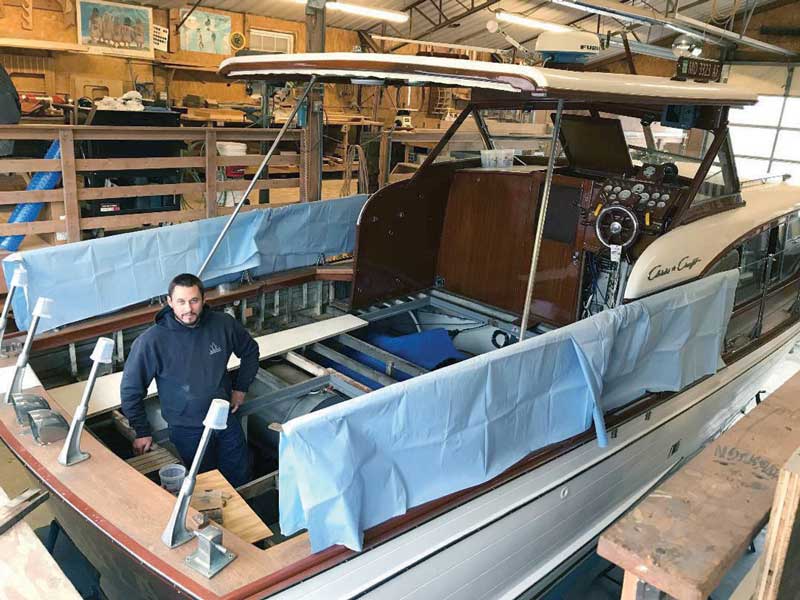 Jared Satchell working on a teak deck replacement on a classic Chris-Craft at Campbell’s Boat Yard in Oxford, MD.