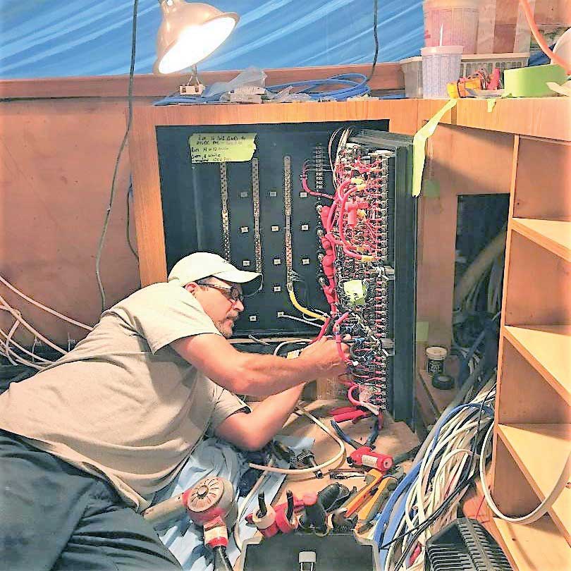 Rick Kendall rewiring the main distribution panel on a 74-foot Spencer Sport Fisherman at Worton Creek Marina in Chestertown, MD.