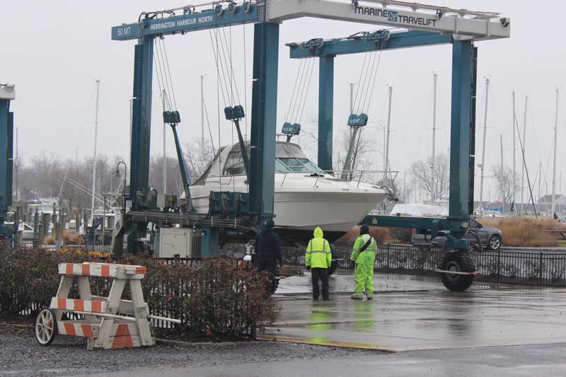 Winter haul outs must go on despite the cold winter rain at Herrington Harbour North in Tracys Landing, MD. Photo by Rick Franke