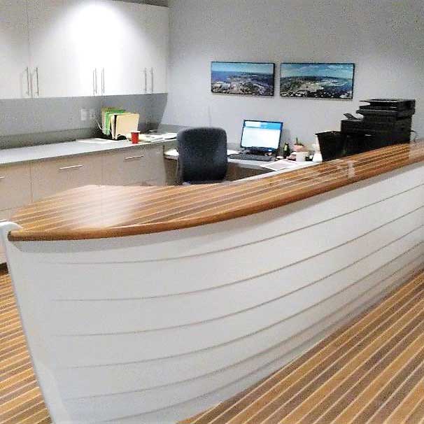 The boat-shaped reception desk at the Annapolis Boat Shows’ new office at 110 Compromise Street was built by Chesapeake Light Craft in Annapolis, MD. Photo by Rick Franke