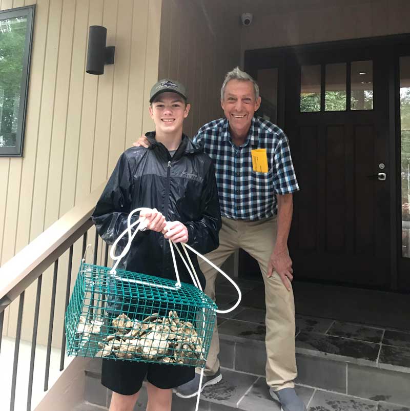 Boy Scout Josh Newmier was able to recruit 23 new property owners to the oyster gardening program, including Dr. Tony Calabro (right). Photo courtesy ShoreRivers