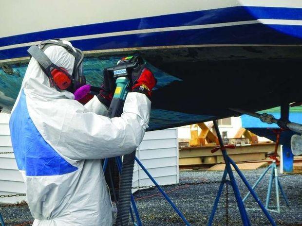 Old bottom paint being peeled, an alternative to soda blasting, at Hartge Yacht Harbor in Galesville, MD.