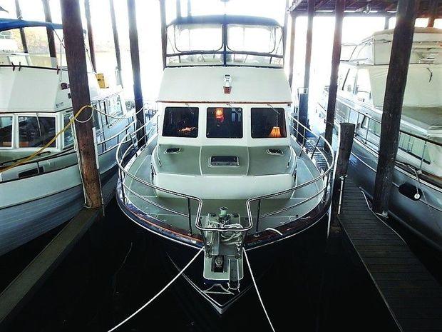 A 1998 Sabreline 47 trawler in a covered slip at Hartge Yacht Harbor in Galesville, MD.