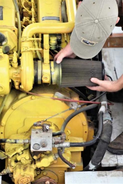 Chesapeake Bay Maritime Museum mechanic Josh Richardson removes the air filter from Dorothy Lee’s engine in the shop at St. Michaels, MD. Chesapeake Bay Maritime Museum mechanic Josh Richardson removes the air filter from Dorothy Lee’s engine in the shop at St. Michaels, MD.