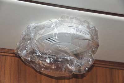 Never cover a smoke detector. If it’s prone to false alarms, replace it with a different unit and/or move the location.