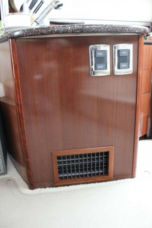 Custom wood grill for heat distribution in salon.